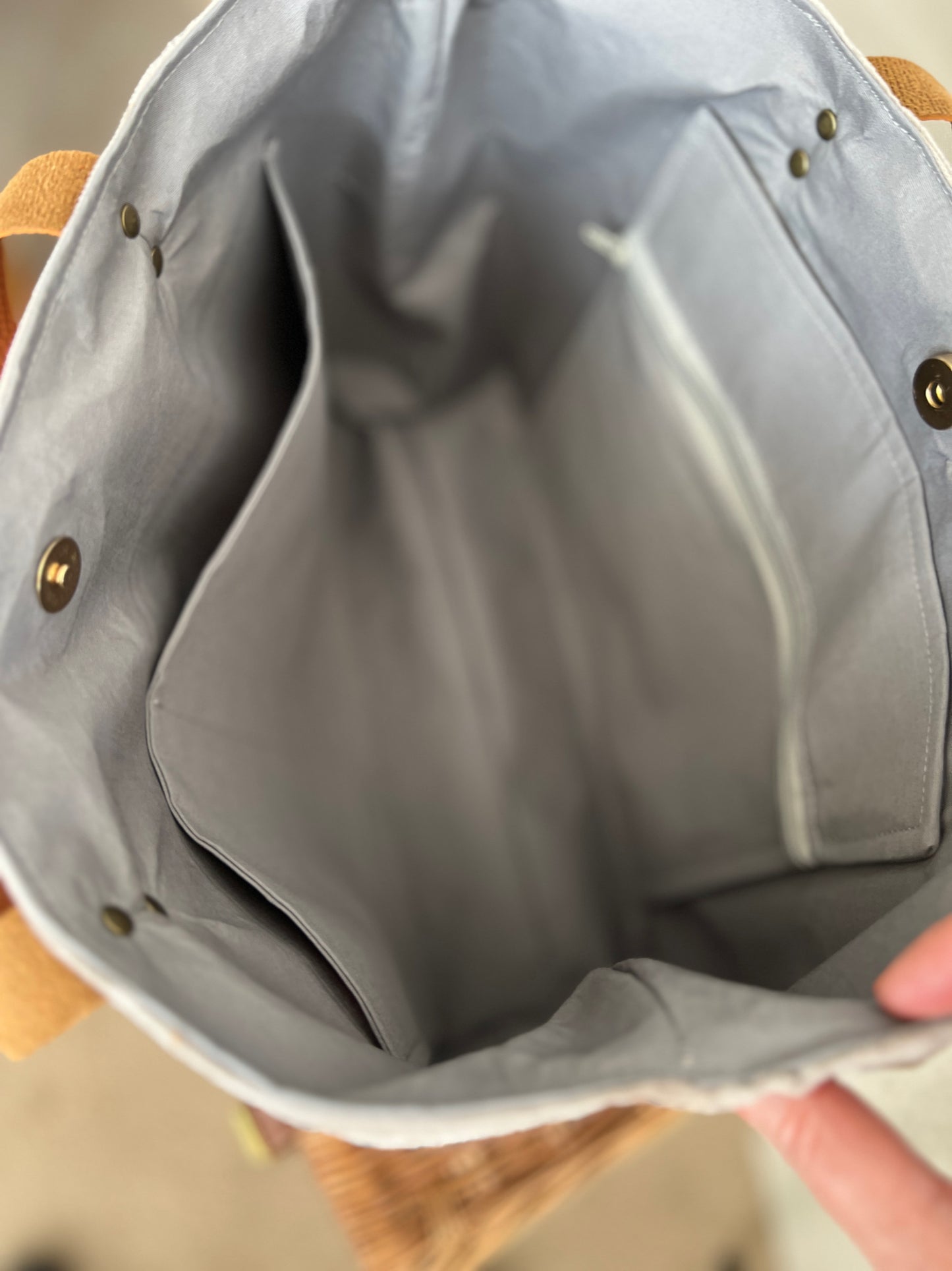 Inside view of upcycled tote bag made from denim, corduroy and cotton fabric scraps with leather handles, 3 inside pockets, on zipped, handmade by Tallulah Riley
