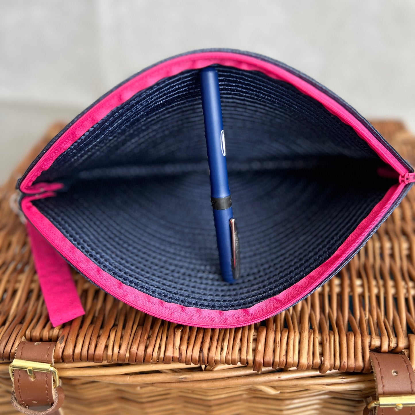 inside view navy blue woven clutch bag with pink zip and pink detachable wristlet, handmade by Tallulah Riley