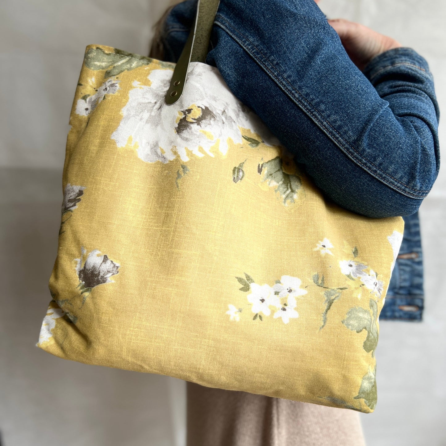 modelled view of lemony yellow tote bag with olive green leather handles to show size, handmade by Tallulah Riley