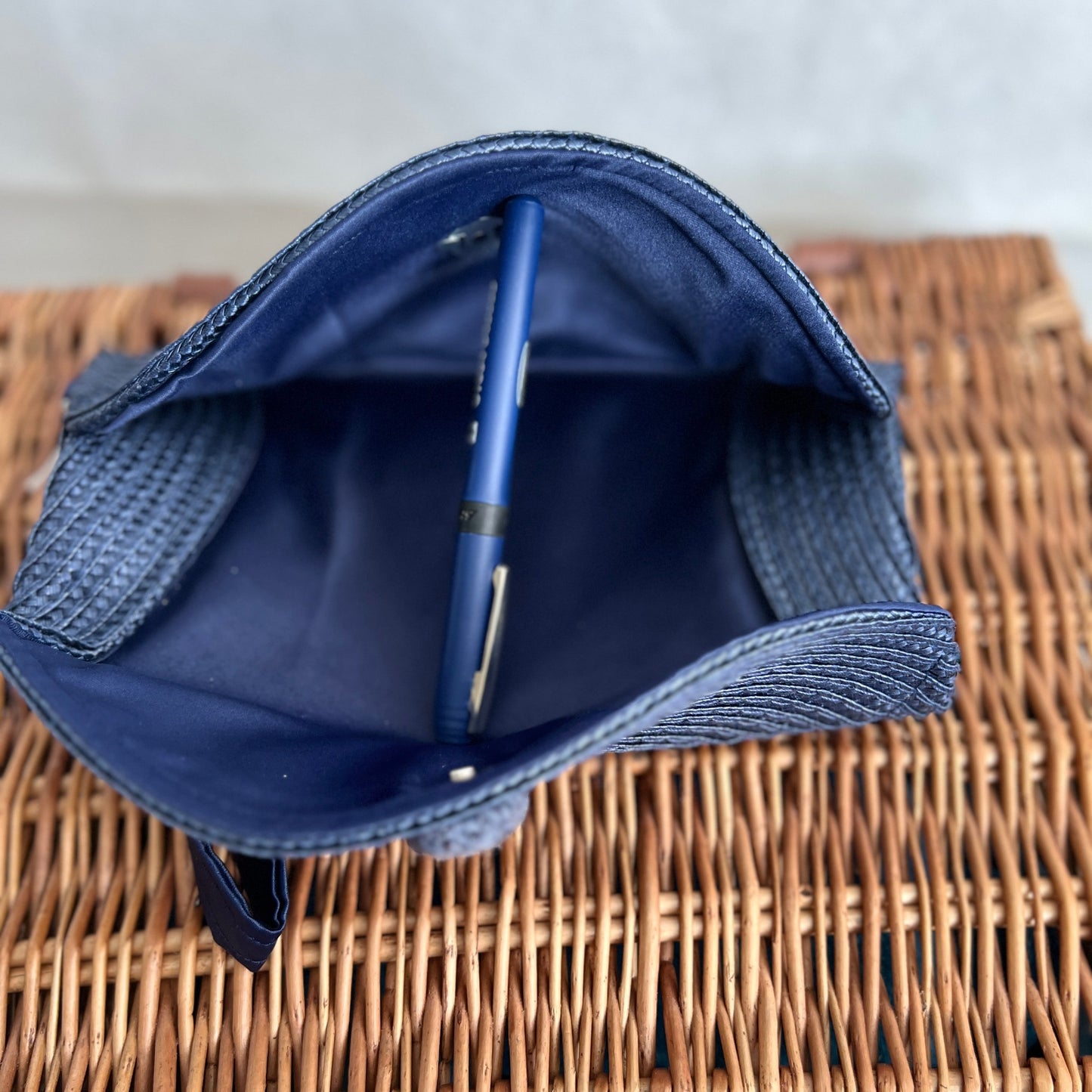 open view of navy blue woven clutch bag with magnetic fastening, handmade by Tallulah Riley