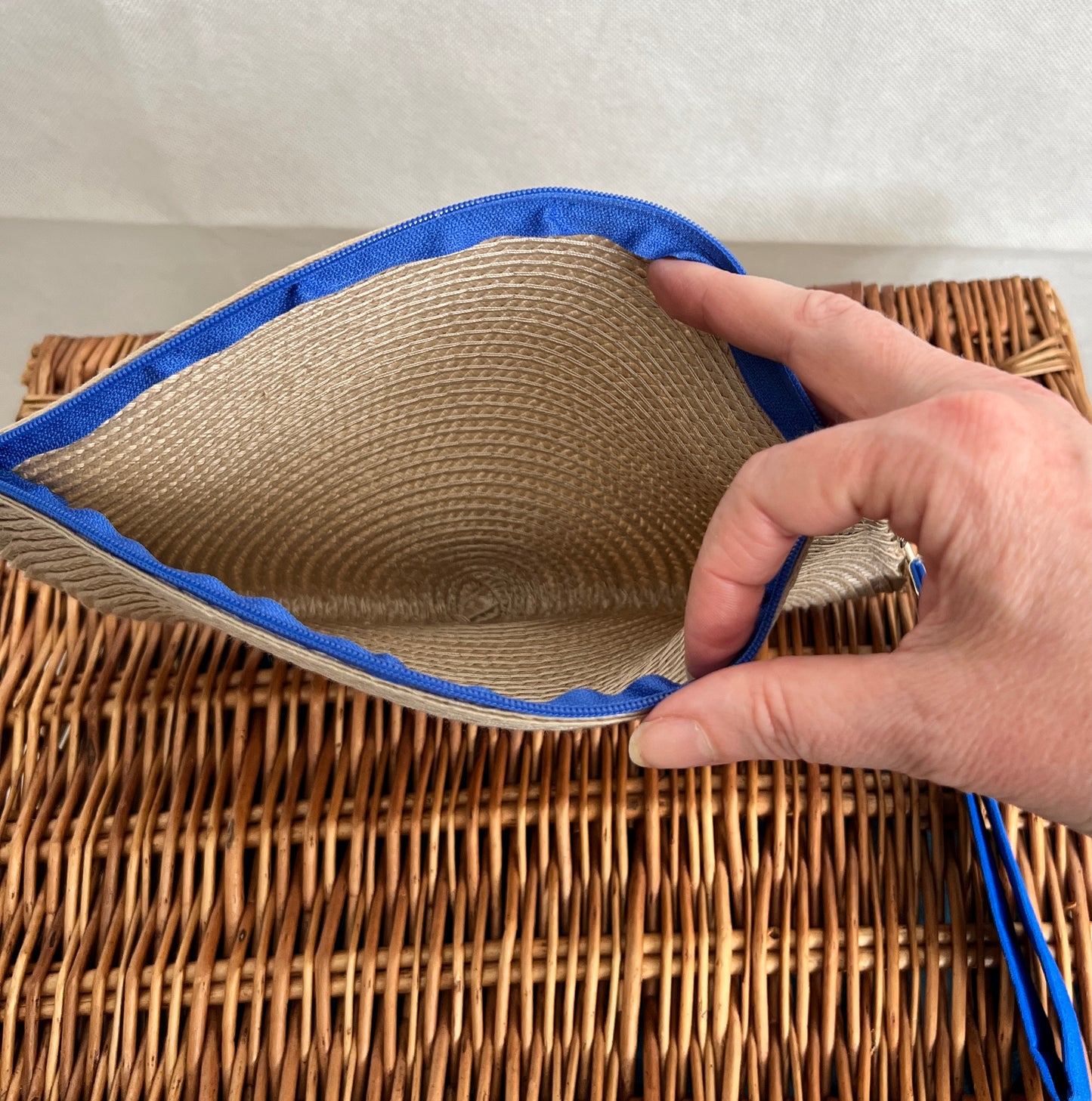 inside view cream woven clutch bag with blue zip and blue detachable wristlet, handmade by Tallulah Riley