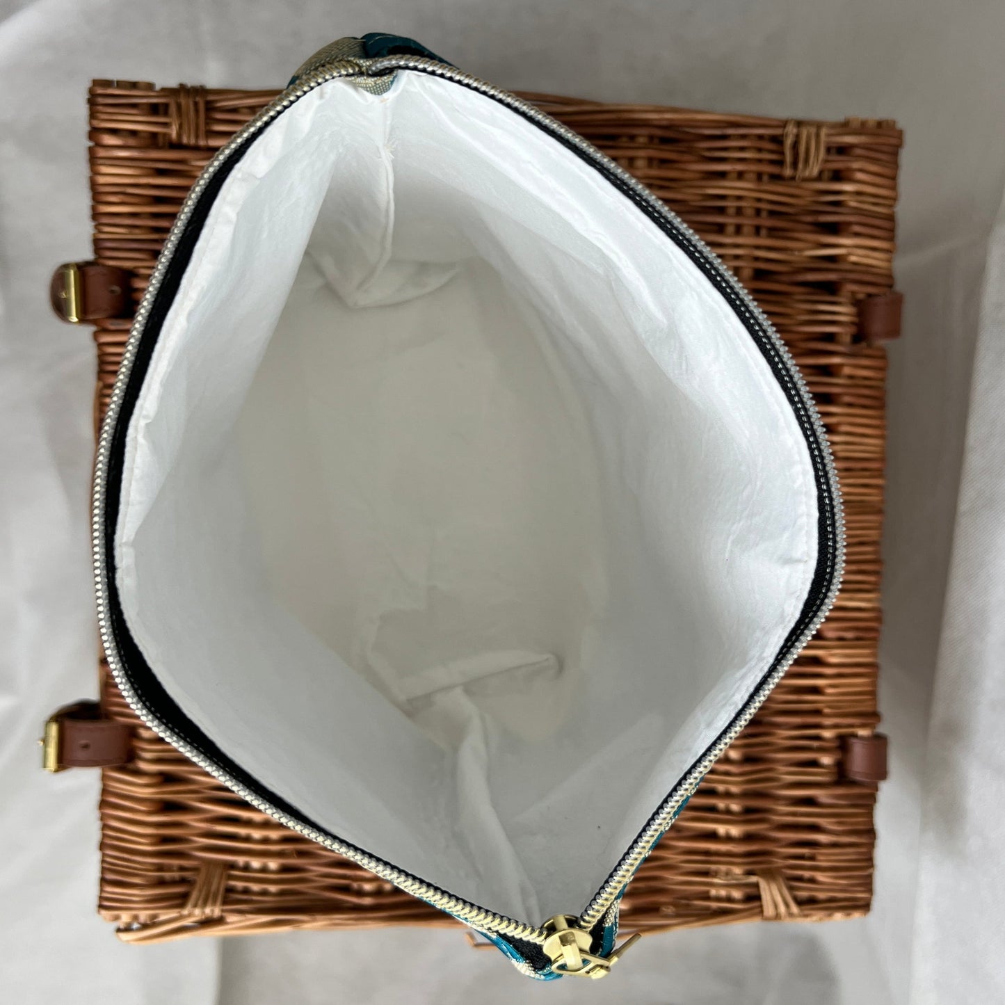 inside view of luxurious gold and teal accessories pouch, make-up bag with gold zip and cream lining, handmade by Tallulah Riley