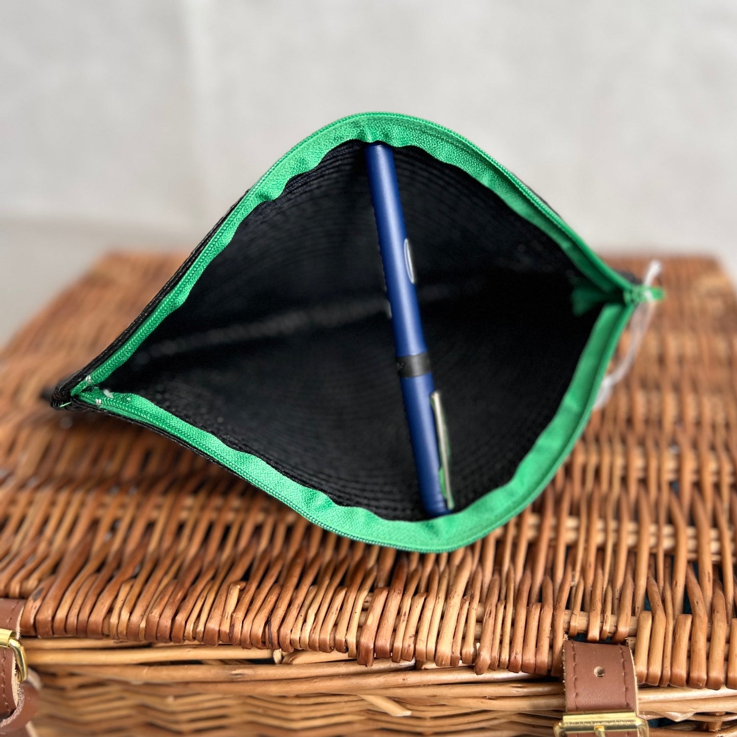 open view of black woven clutch bag with green zip handmade by Tallulah Riley