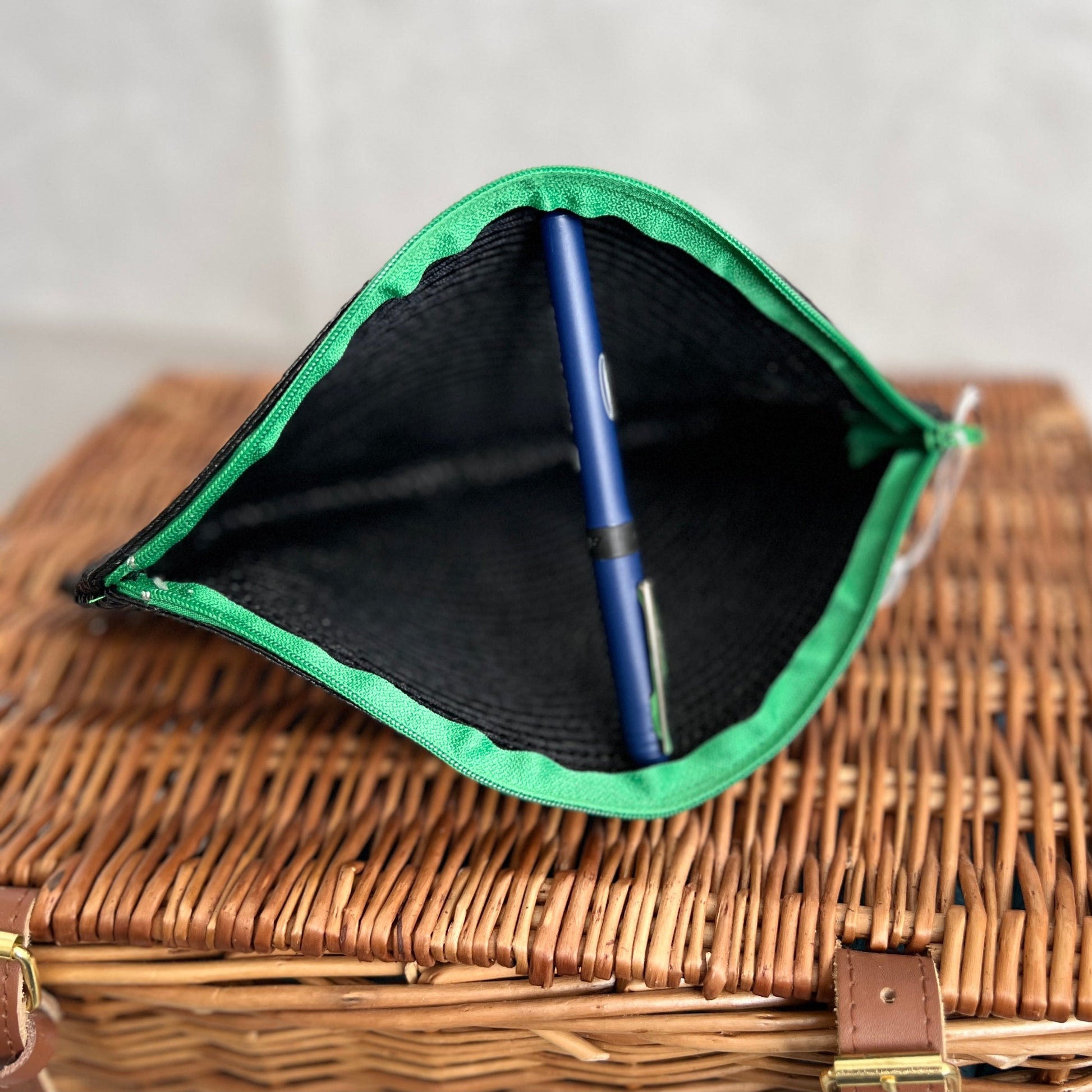 open view of black woven clutch bag with green zip handmade by Tallulah Riley