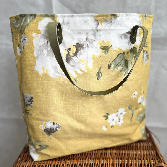 lemony front view of yellow flowery tote bag with olive green leather handles, handmade by Tallulah Riley