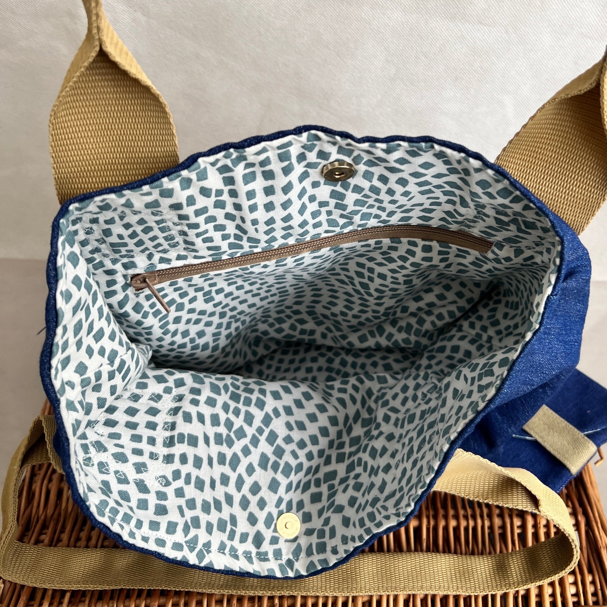 inside view of soft denim tote bag with beighe handles and matching wallet, contrasting fabric with zipped internal pocket and gold magnetic fastening, handmade by Tallulah Riley