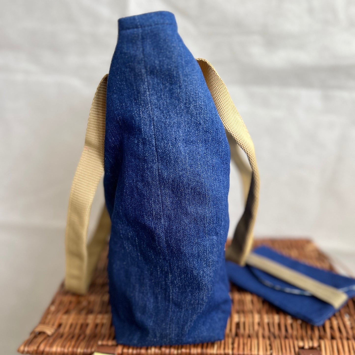 side view of soft denim tote bag with beige handles and matching wallet, handmade by Tallulah Riley
