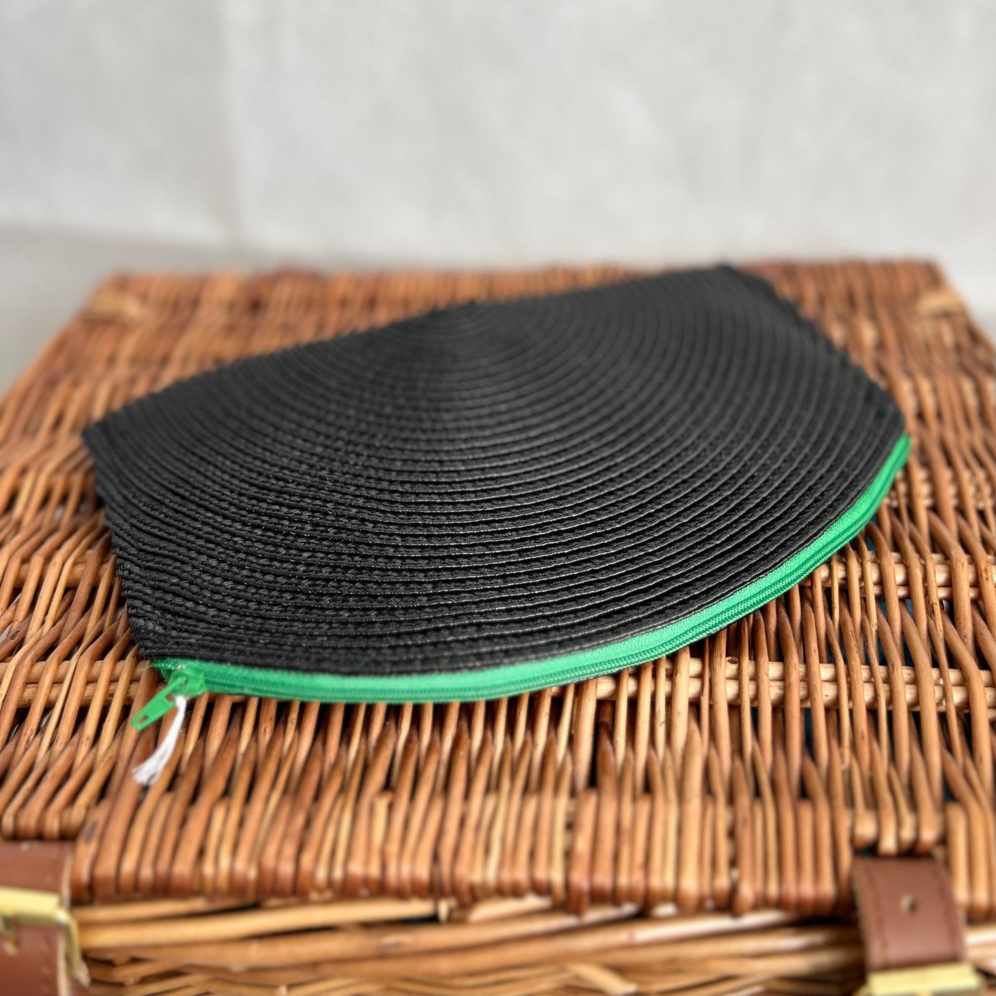 Black woven clutch bag with green zip handmade by Tallulah Riley