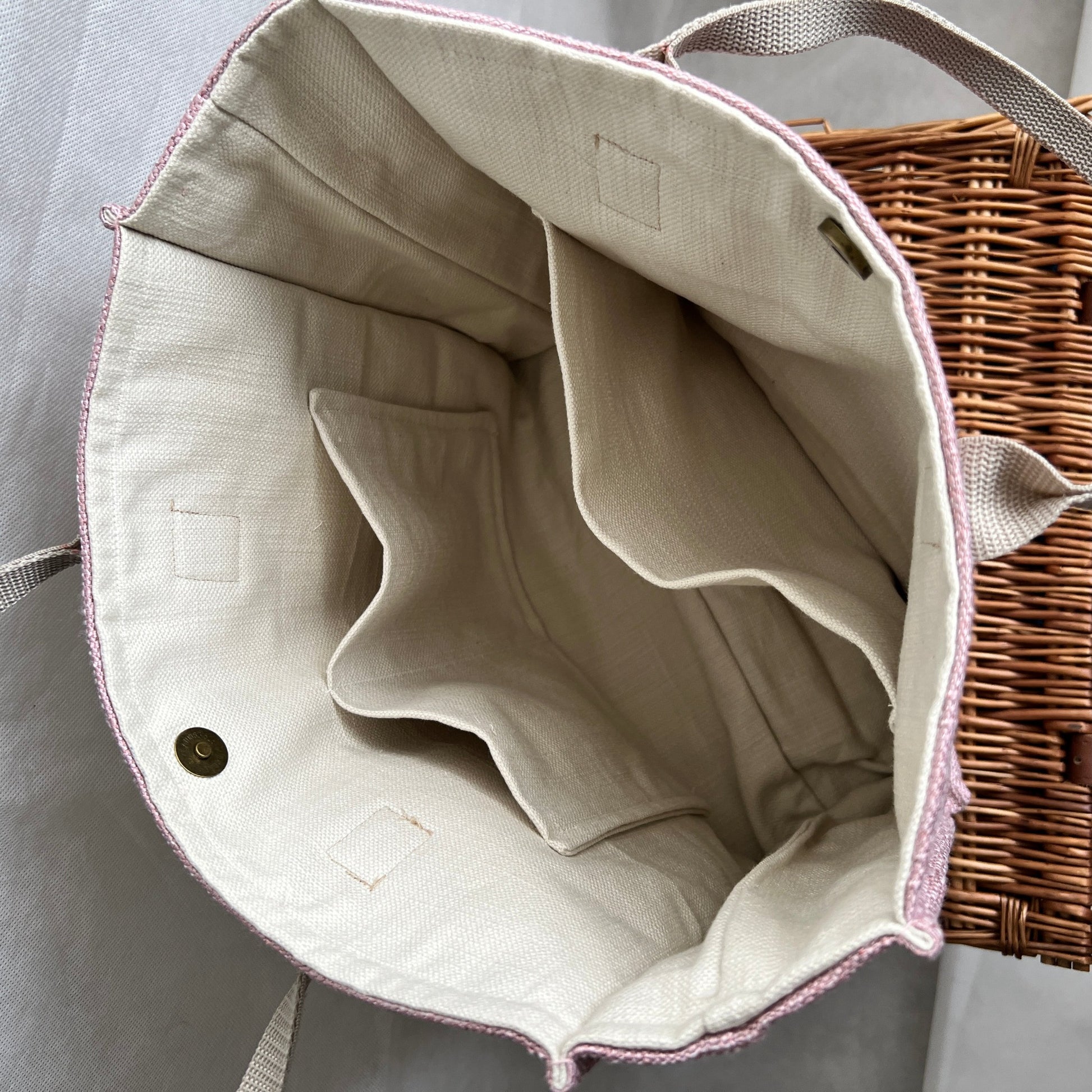 inside view of pink tweed style boxy tote bag with cream lining and three internal pockets and antique brass magnetic closure, handmade by Tallulah Riley