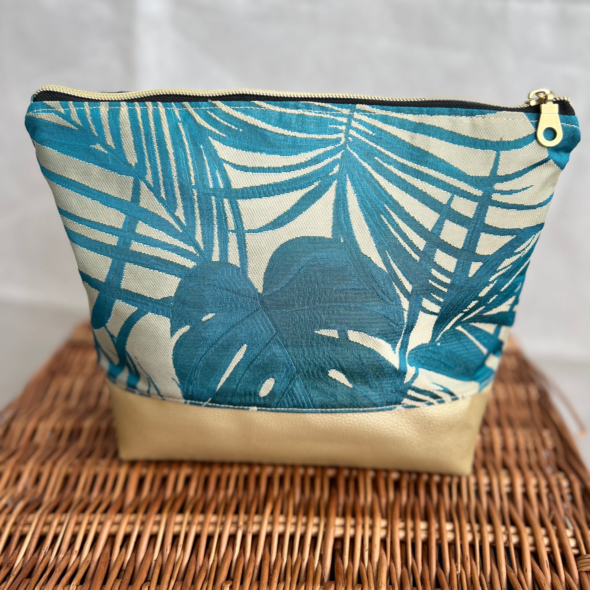 front view of luxurious accessories, make-up pouch, bag with gold faux leather and teal and gold fabric with gold zip, handmade by Tallulah Riley