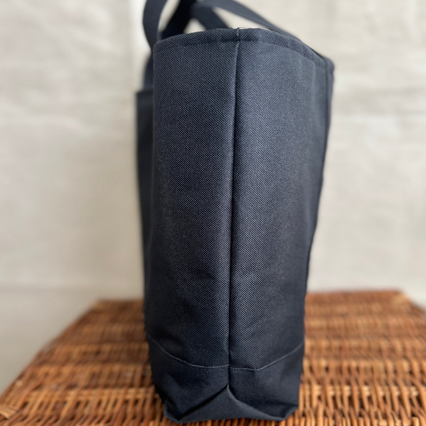 side view of navy blue waterproof canvas strong tote bag with short handles, handmade by Tallulah Riley
